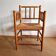 Antique Dutch chair with bobbins and a straw seat.