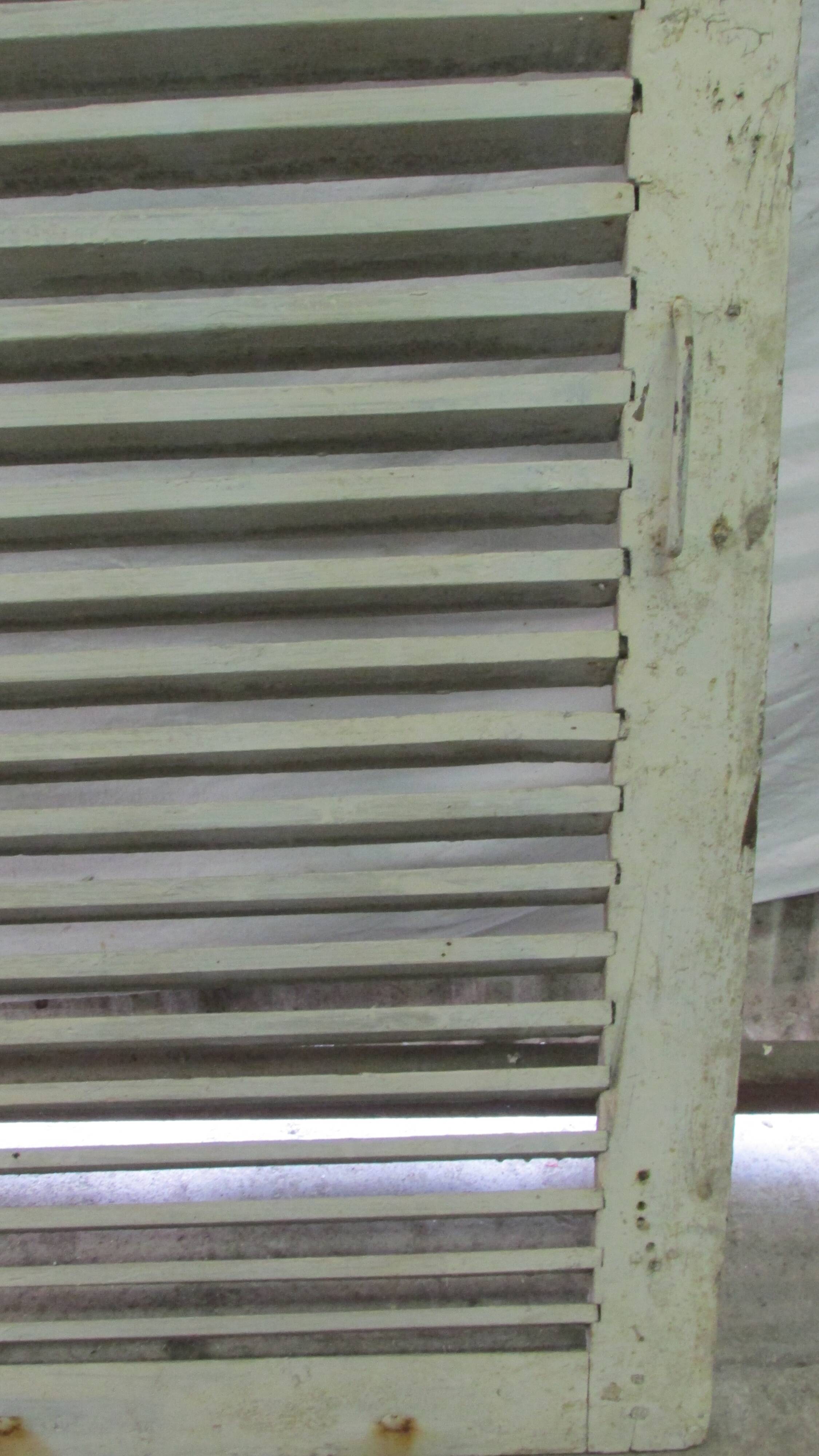 Old wooden shutter with perforations.