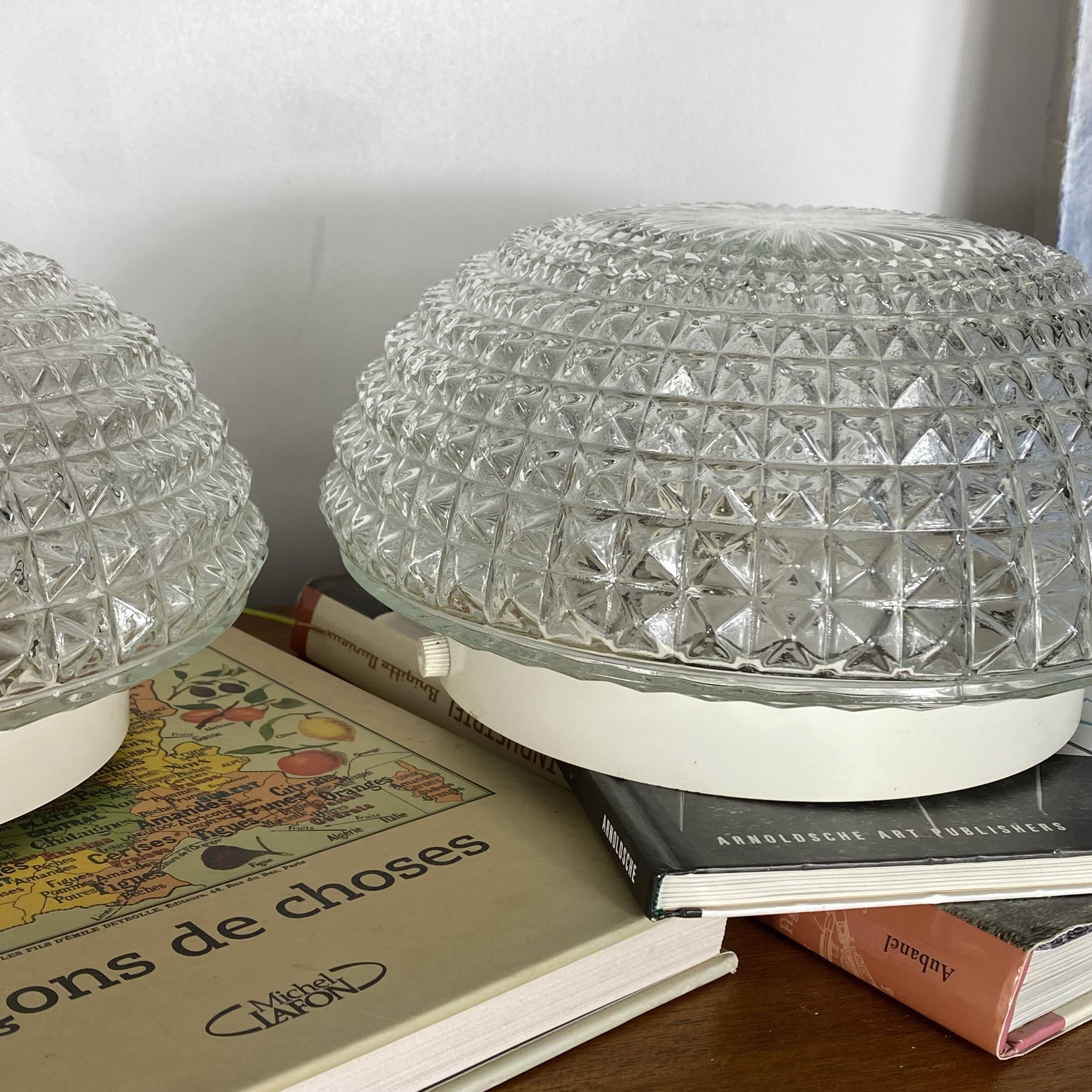 Large pair of round wall sconces ceiling lights in transparent glass.