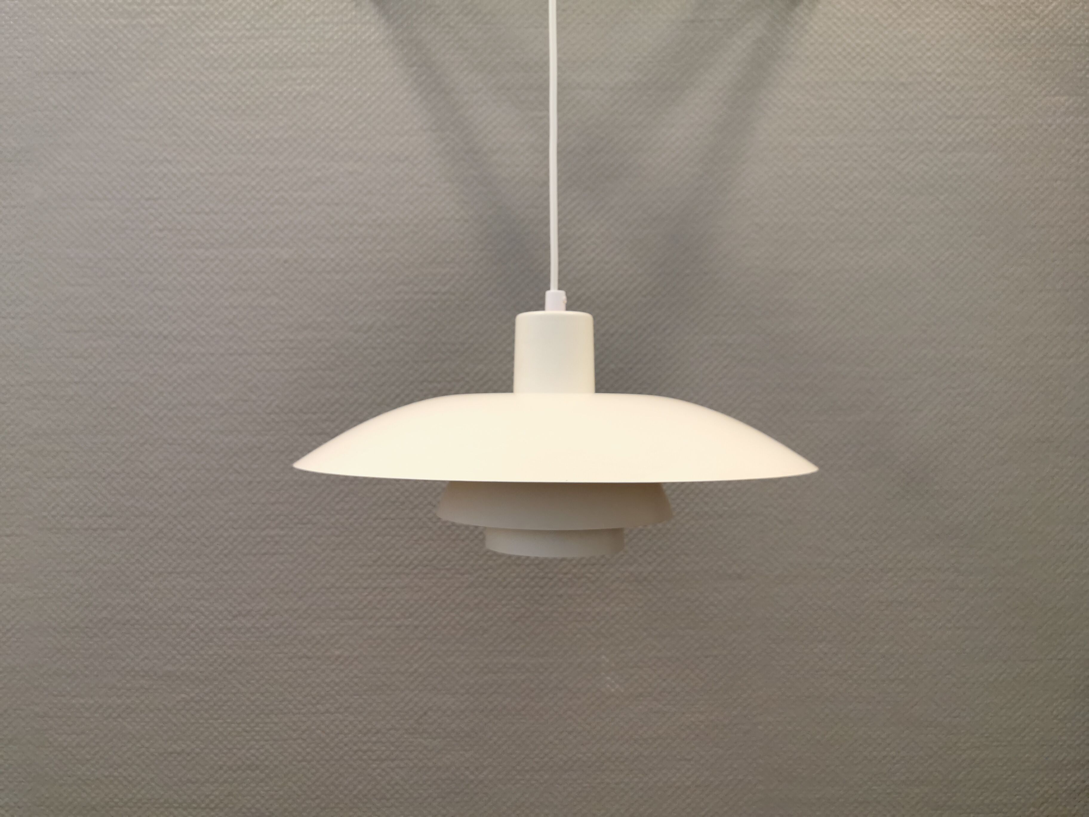 Older ph 4/3 hanging lamp, in white, with original orange suspension disk.