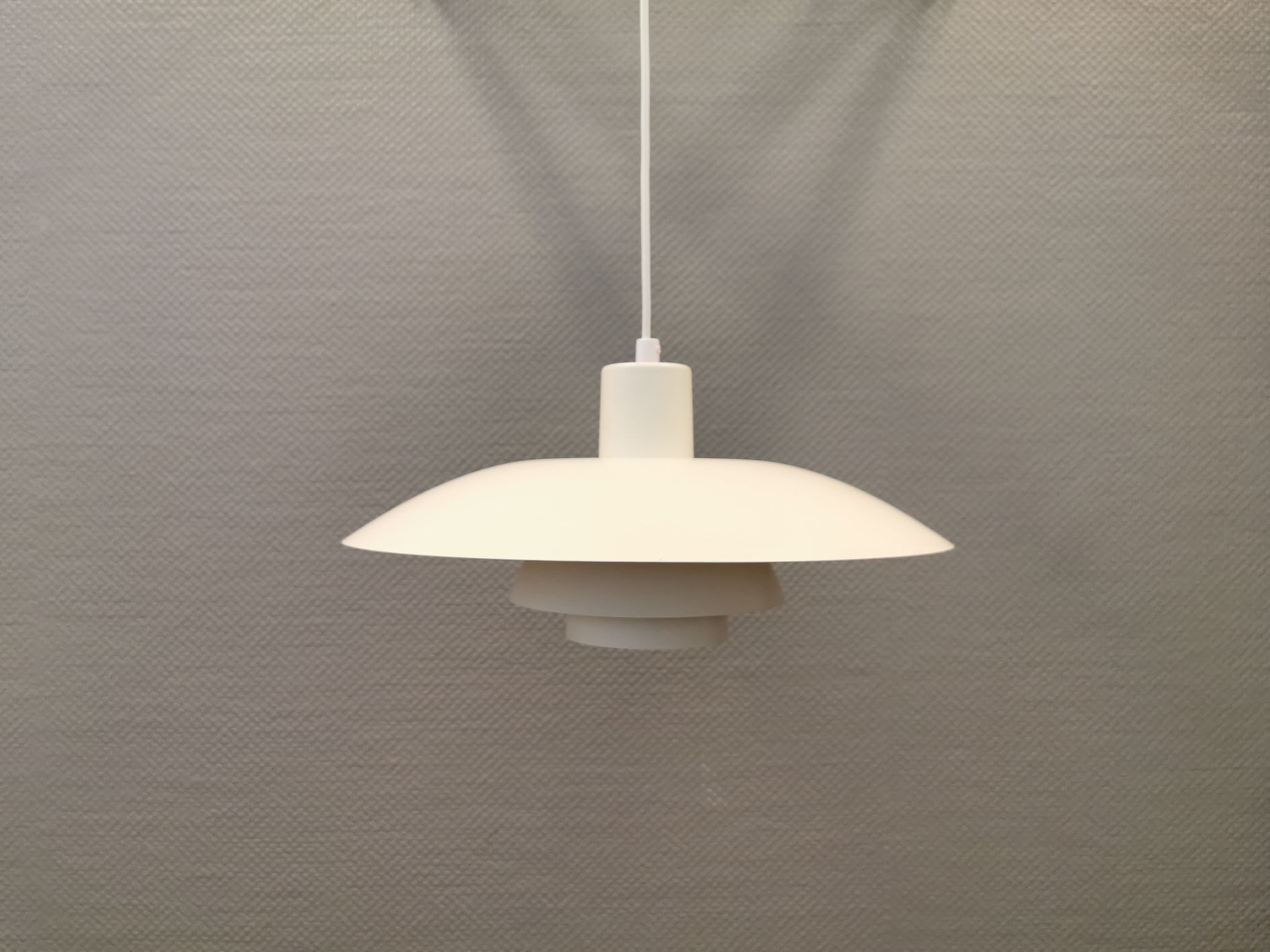 Older ph 4/3 hanging lamp, in white, with original orange suspension disk.