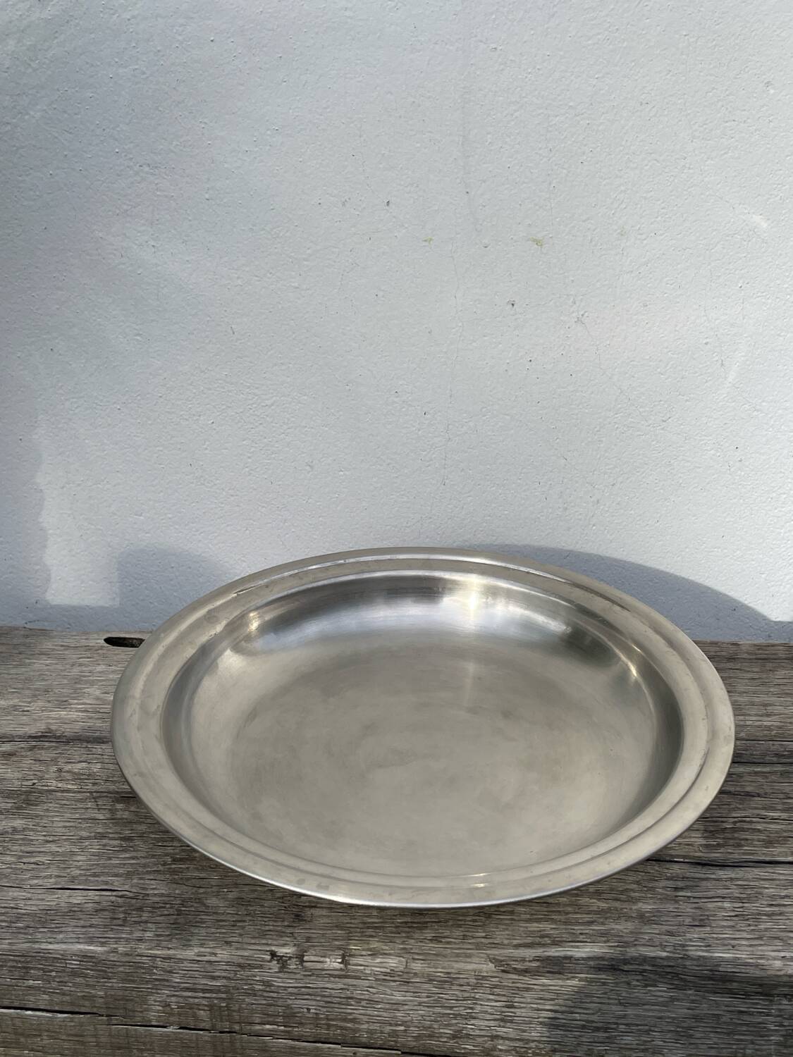 Round silver-plated metal serving dish with hallmark