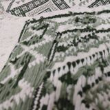 Handwoven white and green rug