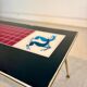 Vintage 70s coffee table – red & black graphic top – laito
