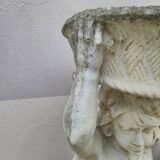 Antique reconstituted stone planter depicting a cherub