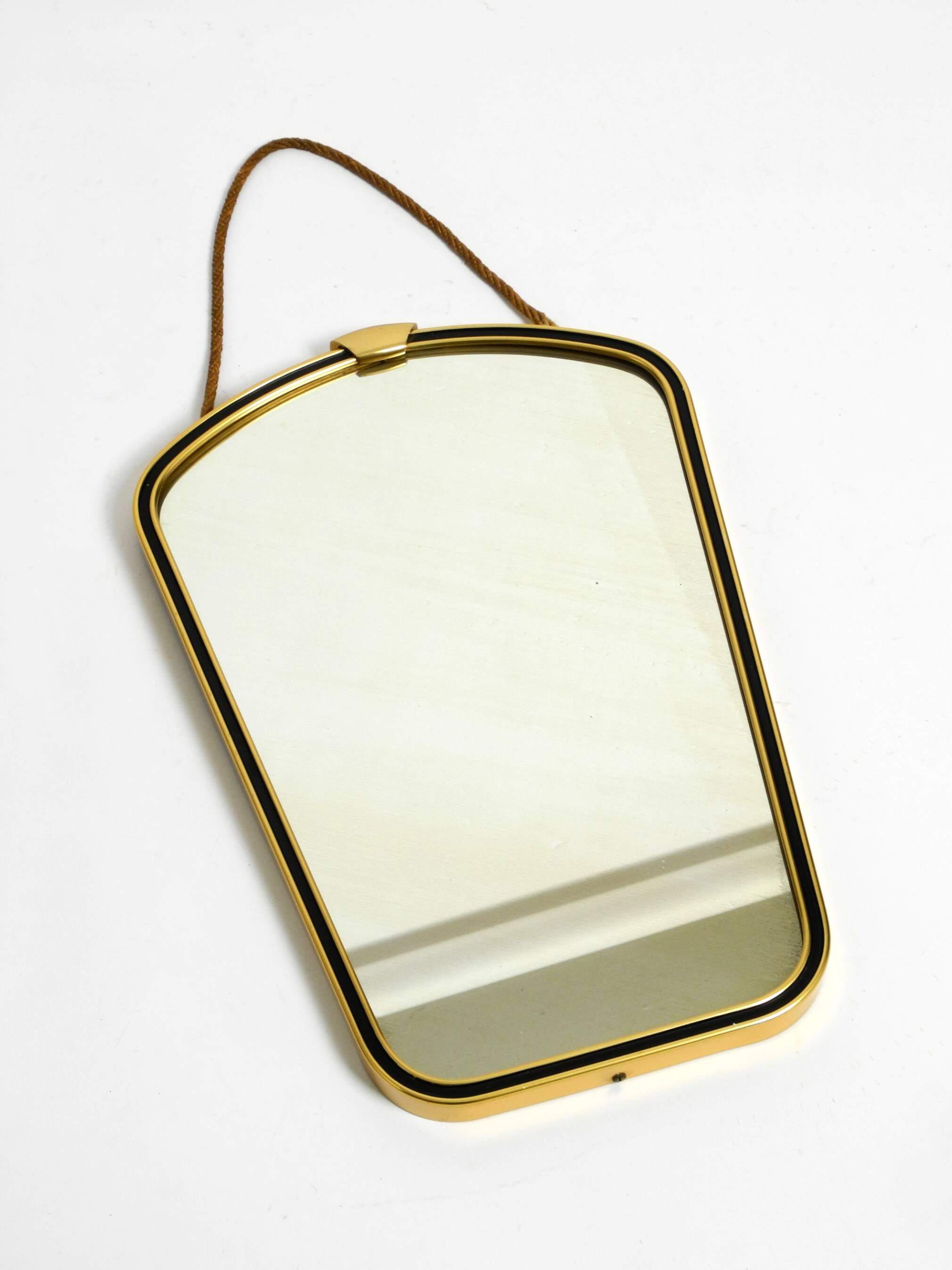 Beautiful small mid-century brass wall mirror with braided hanging strap