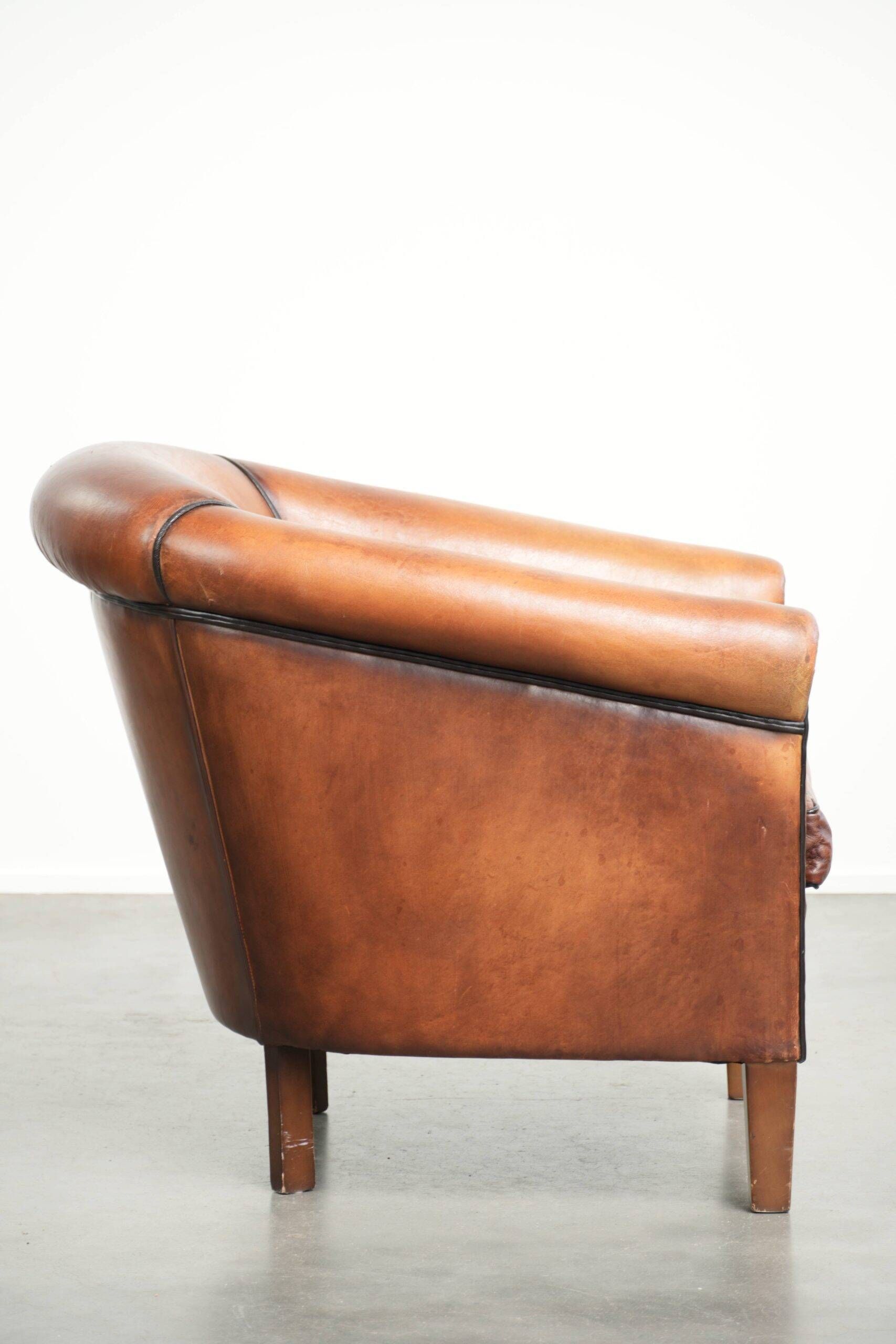 Vintage sheepskin club armchair finished with black piping