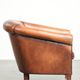 Vintage sheepskin club armchair finished with black piping