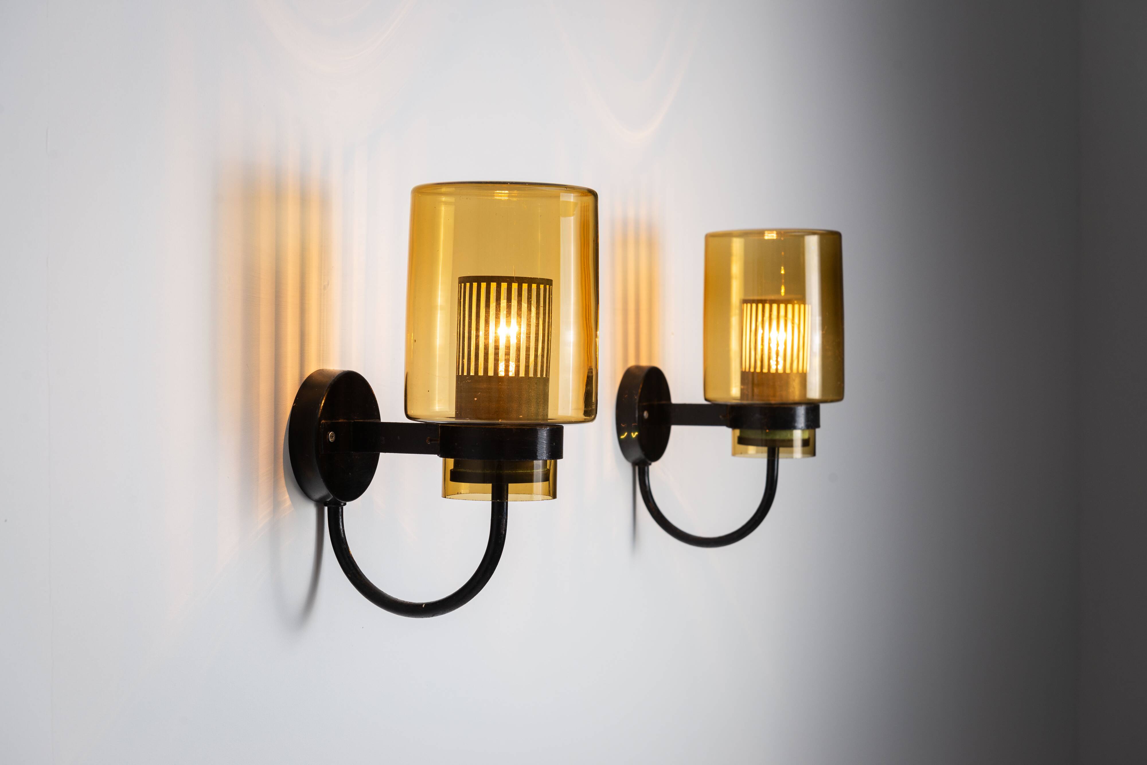 Pair of black metal wall lamps with yellow shades and inner diffuser