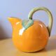 Orange pitcher in slip