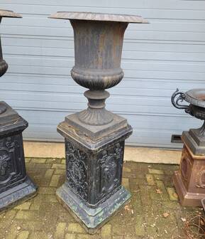 Large antique cast iron vases on pedestal