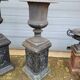 Large antique cast iron vases on pedestal
