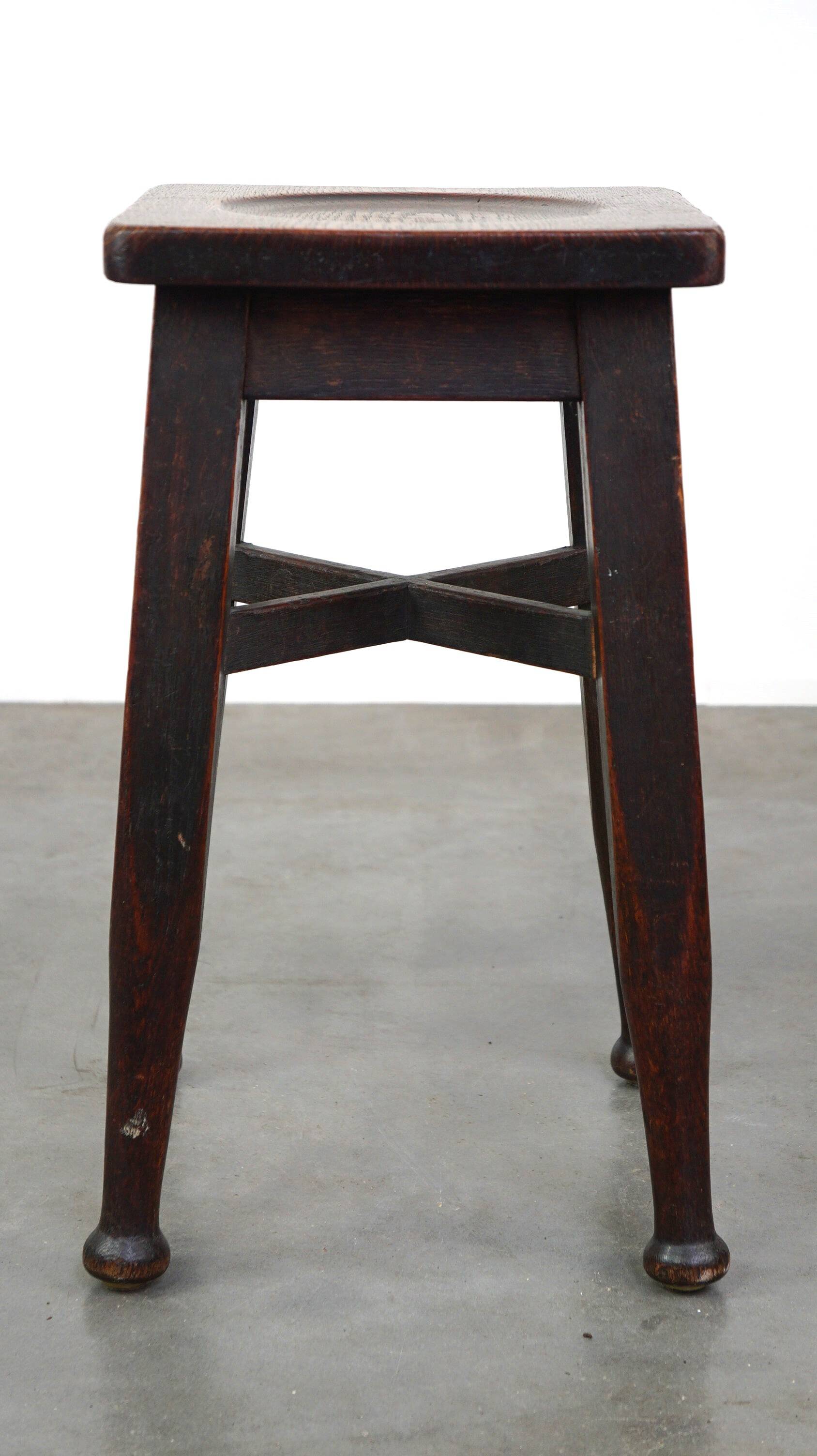 Antique English solid oak stool with a touch of art nouveau style