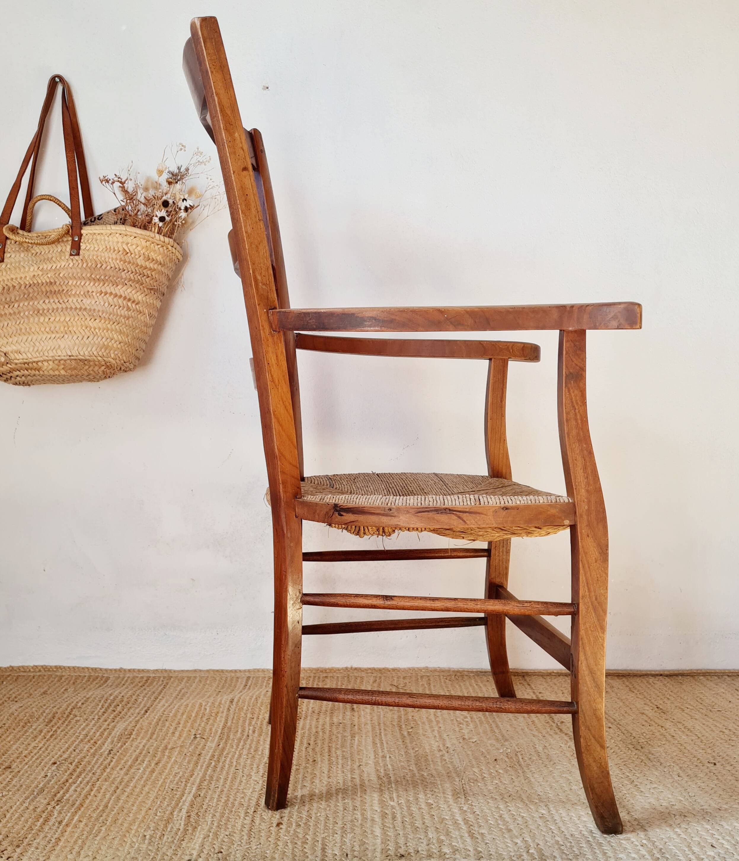 Antique campaign chair in wood and straw