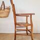 Antique campaign chair in wood and straw