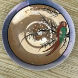 Bird-decorated cup and cup with golden reflection