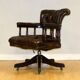 Restored Chesterfield captain's armchair in leather with an oak frame.
