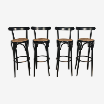 Suite de 4 tabourets de bar en cannage et bois noirci