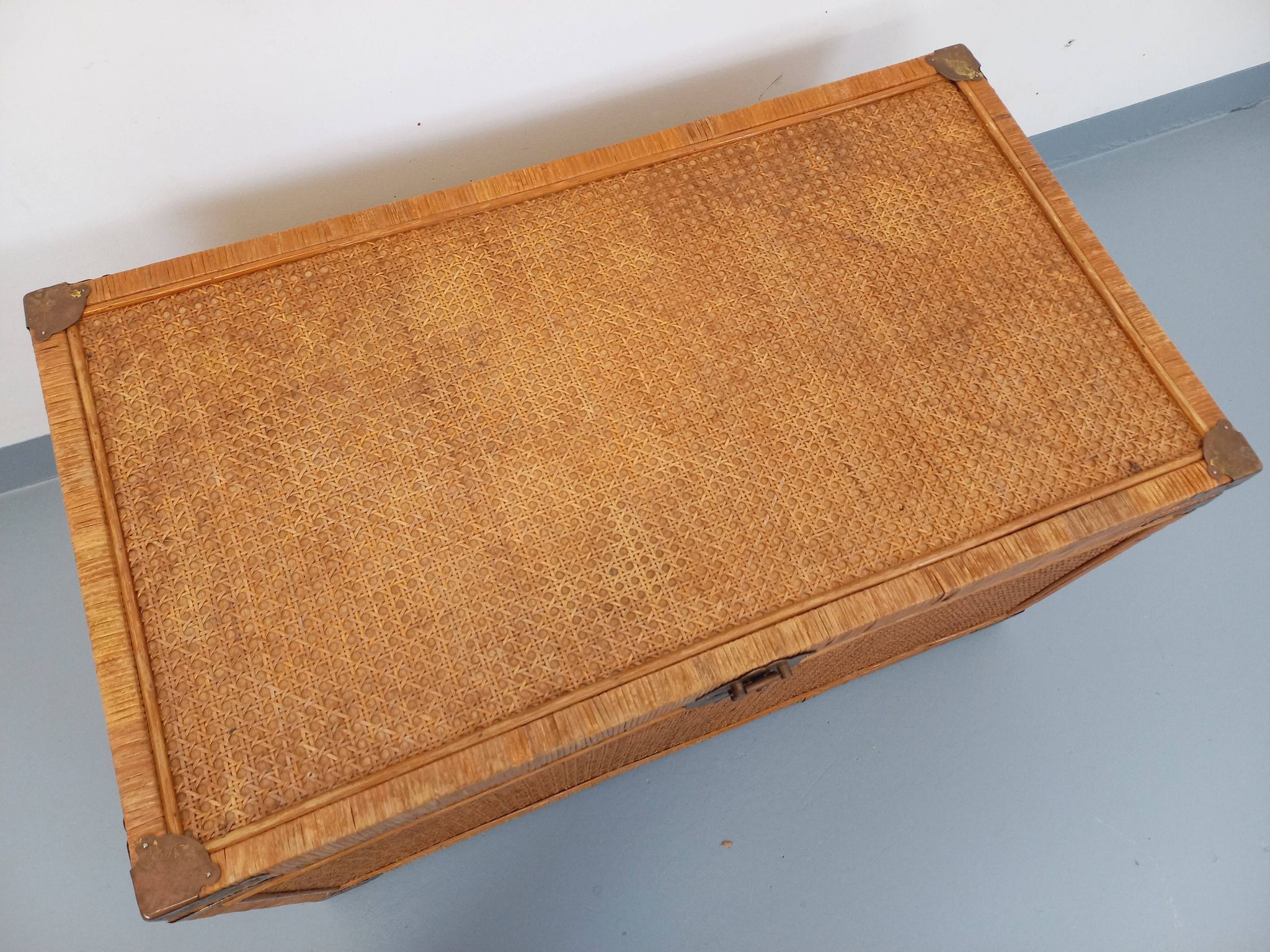 Vintage trunk in wood, rattan, caning, and brass.