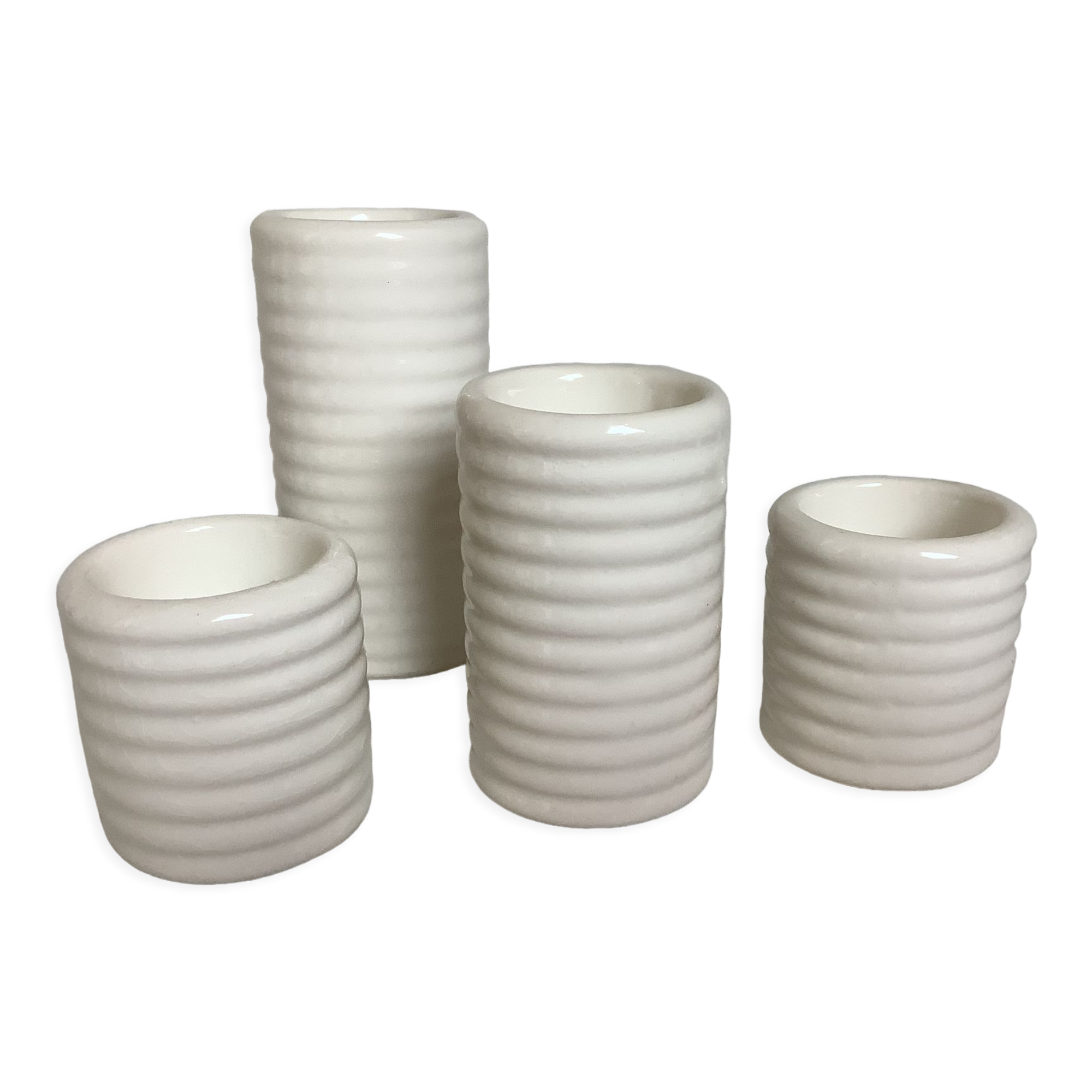 Four white earthenware candle holders
