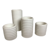 Four white earthenware candle holders