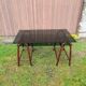 Smoked glass desk on rattan legs and leather detail