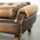 Ottoman chesterfield anglais en cuir élégant, fini avec des clous décoratifs.