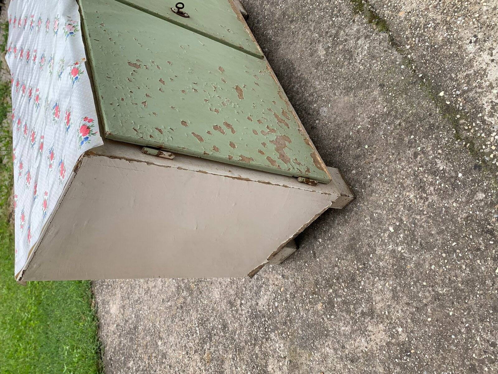 Vintage low wooden cabinet painted green and white with a floral fabric top (1950s)