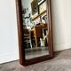 Full-length rectangular mirror in dark wood