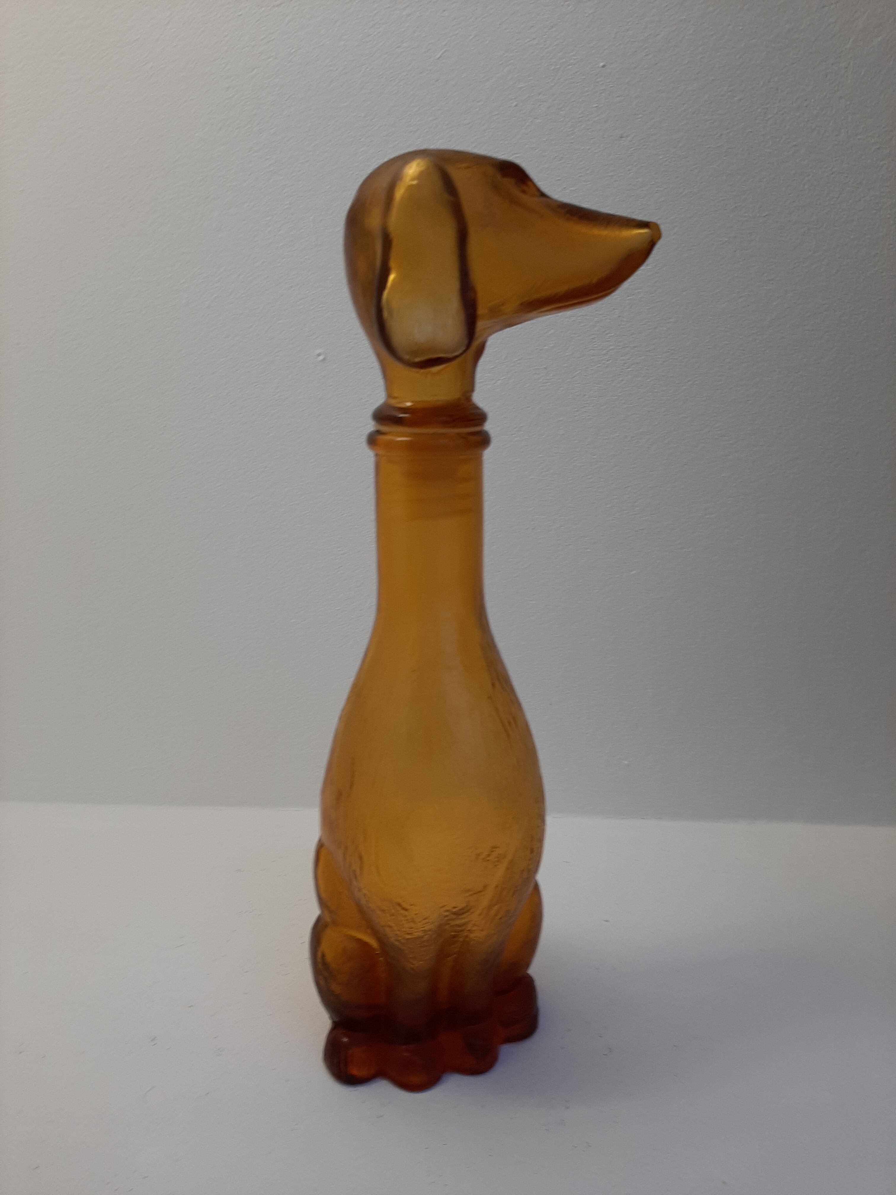 Amber glass bottle representing a dog, Empoli Italy 60s