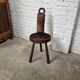Antique tripod chair in solid wood and animal skin.