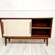 Mid-century teak sideboard with white synthetic doors.