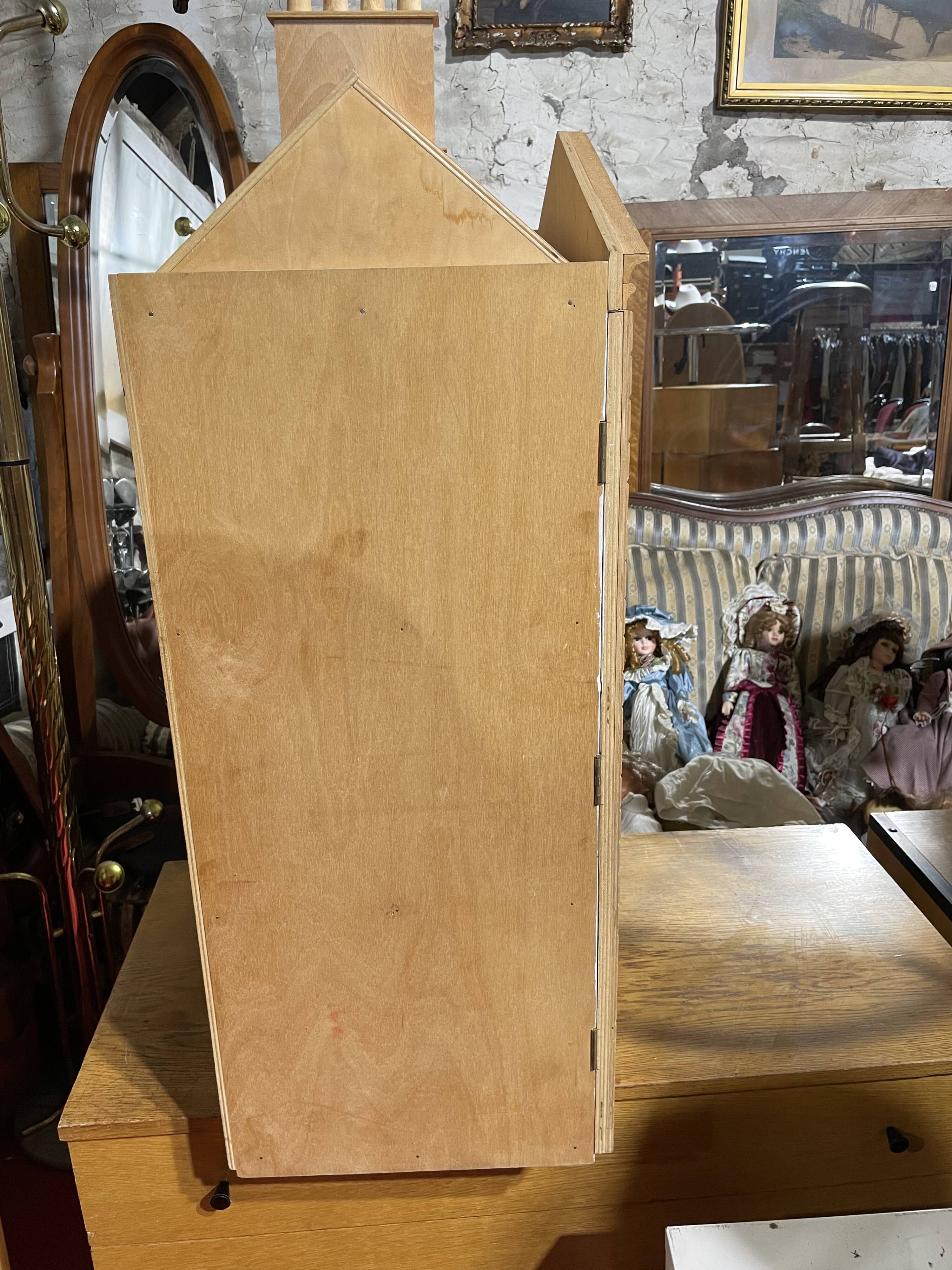 Large wooden dollhouse with miniature furniture