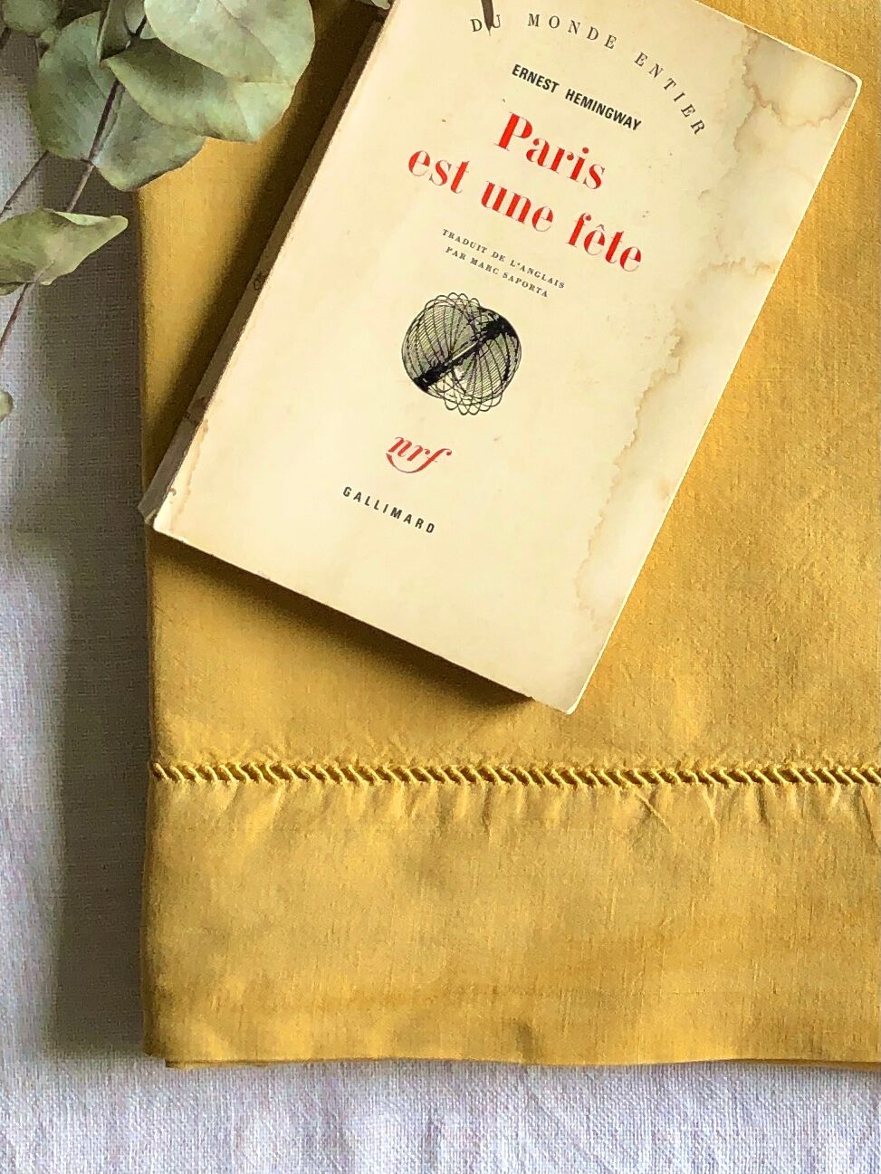 Old linen and cotton sheet tinted in curry yellow