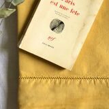 Old linen and cotton sheet tinted in curry yellow
