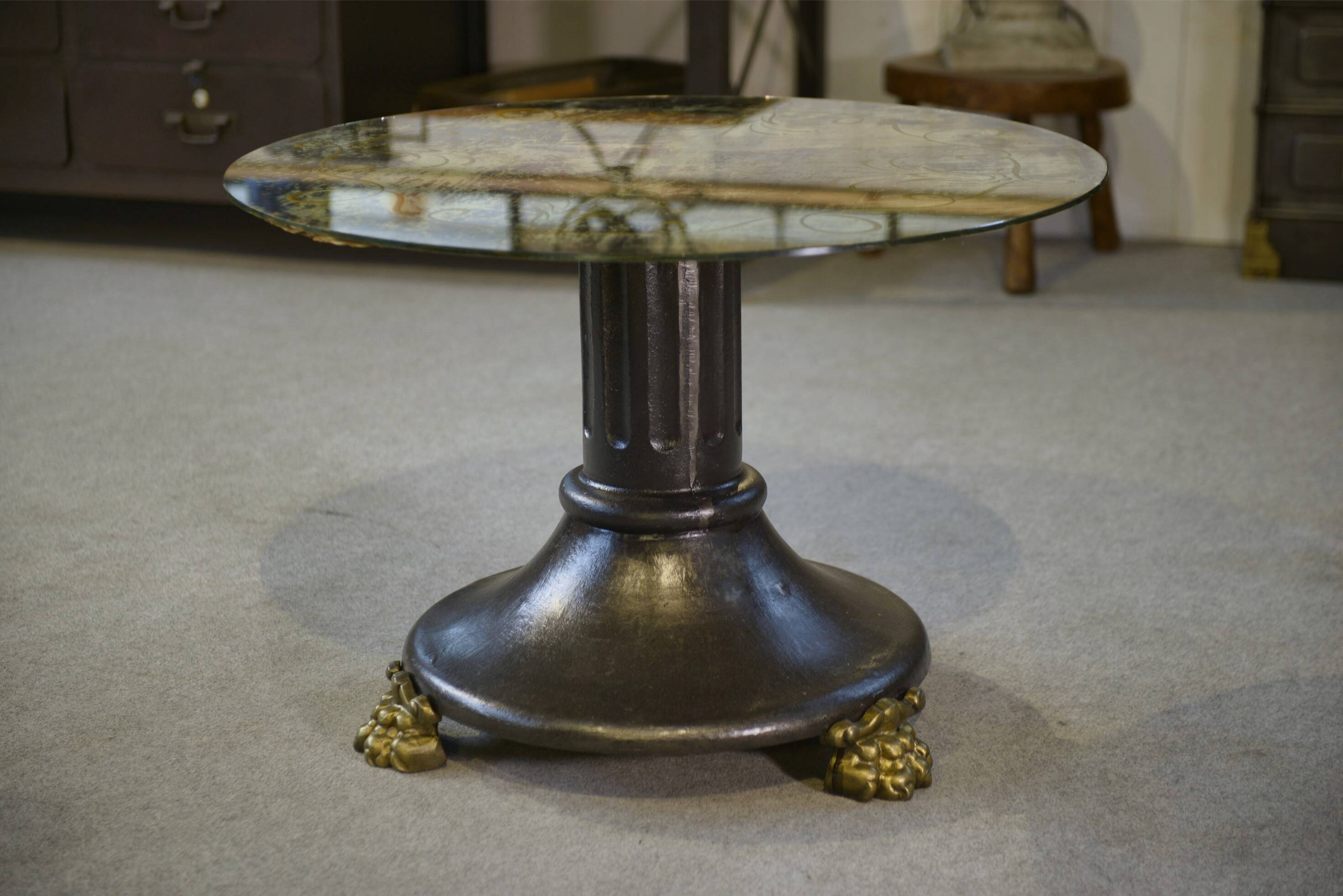 Neo-classical cast iron and glass eglomisé coffee table from the 1940s.