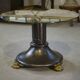Neo-classical cast iron and glass eglomisé coffee table from the 1940s.