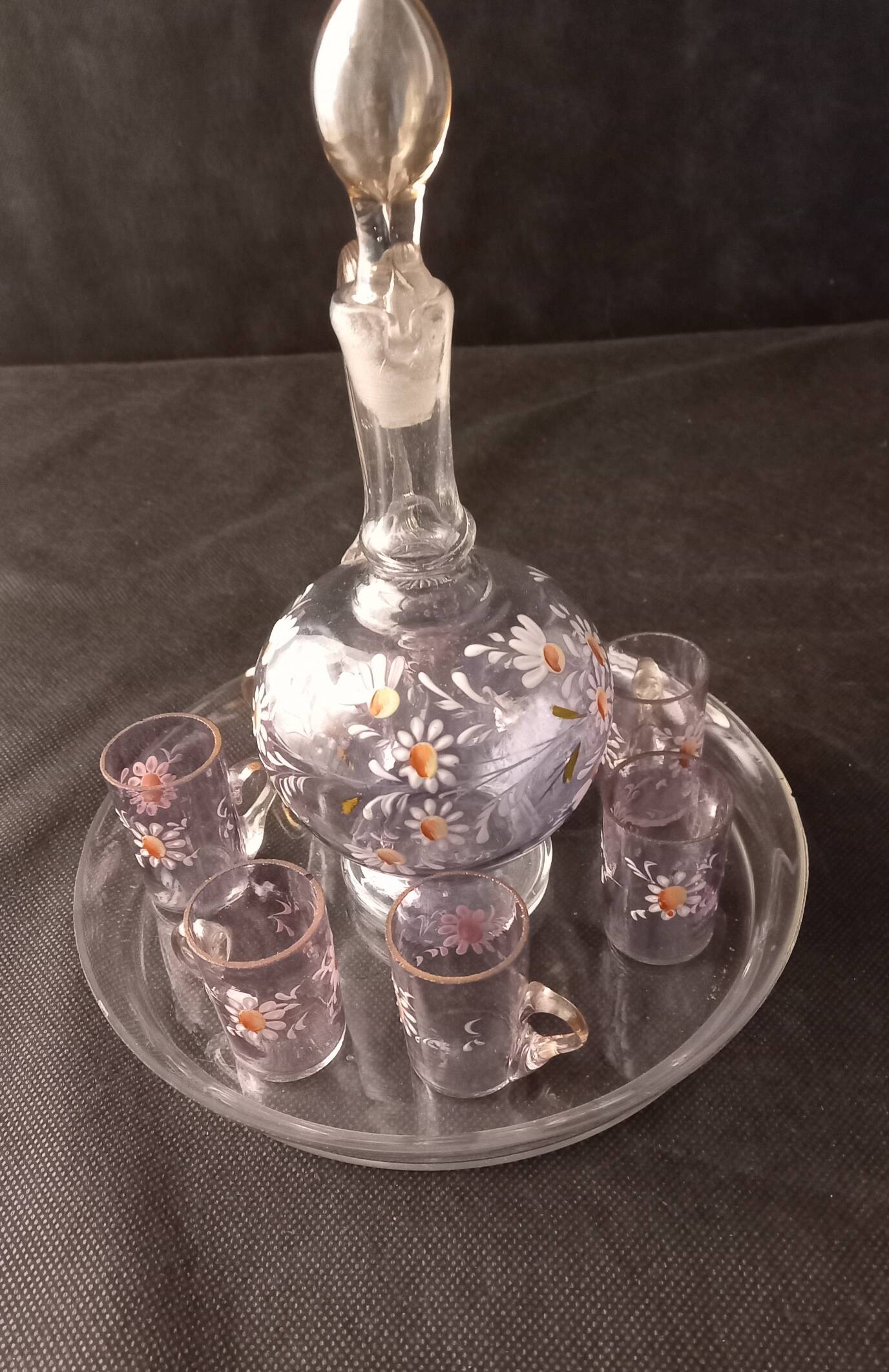 Small liqueur carafe and 7 matching painted glass glasses.