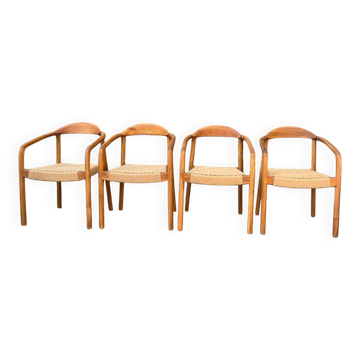 Set of 4 solid wood chairs with cord and armrests.