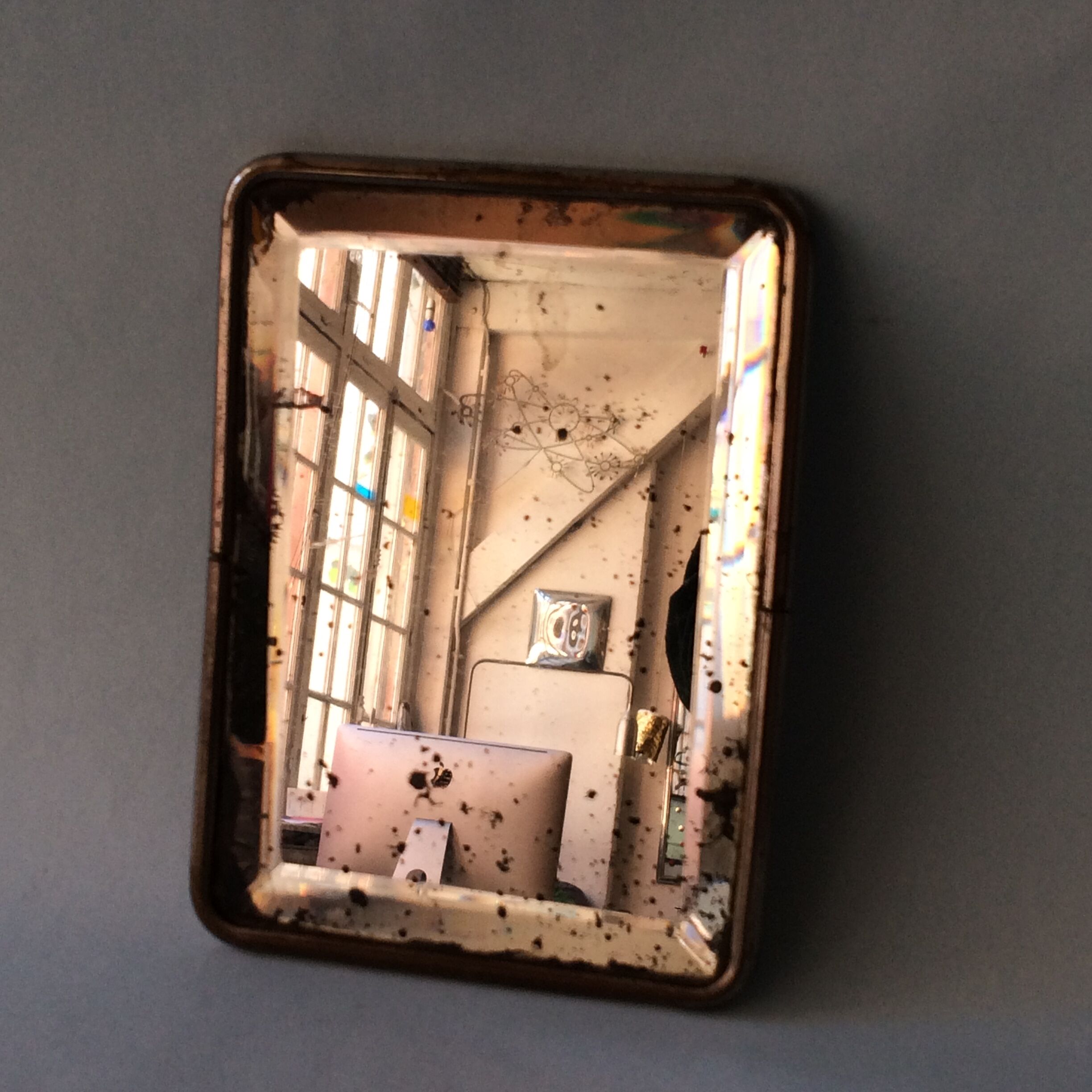 Antique travel mirror with a wide bevel