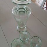 Carafe of green-striped liquor and its three glasses