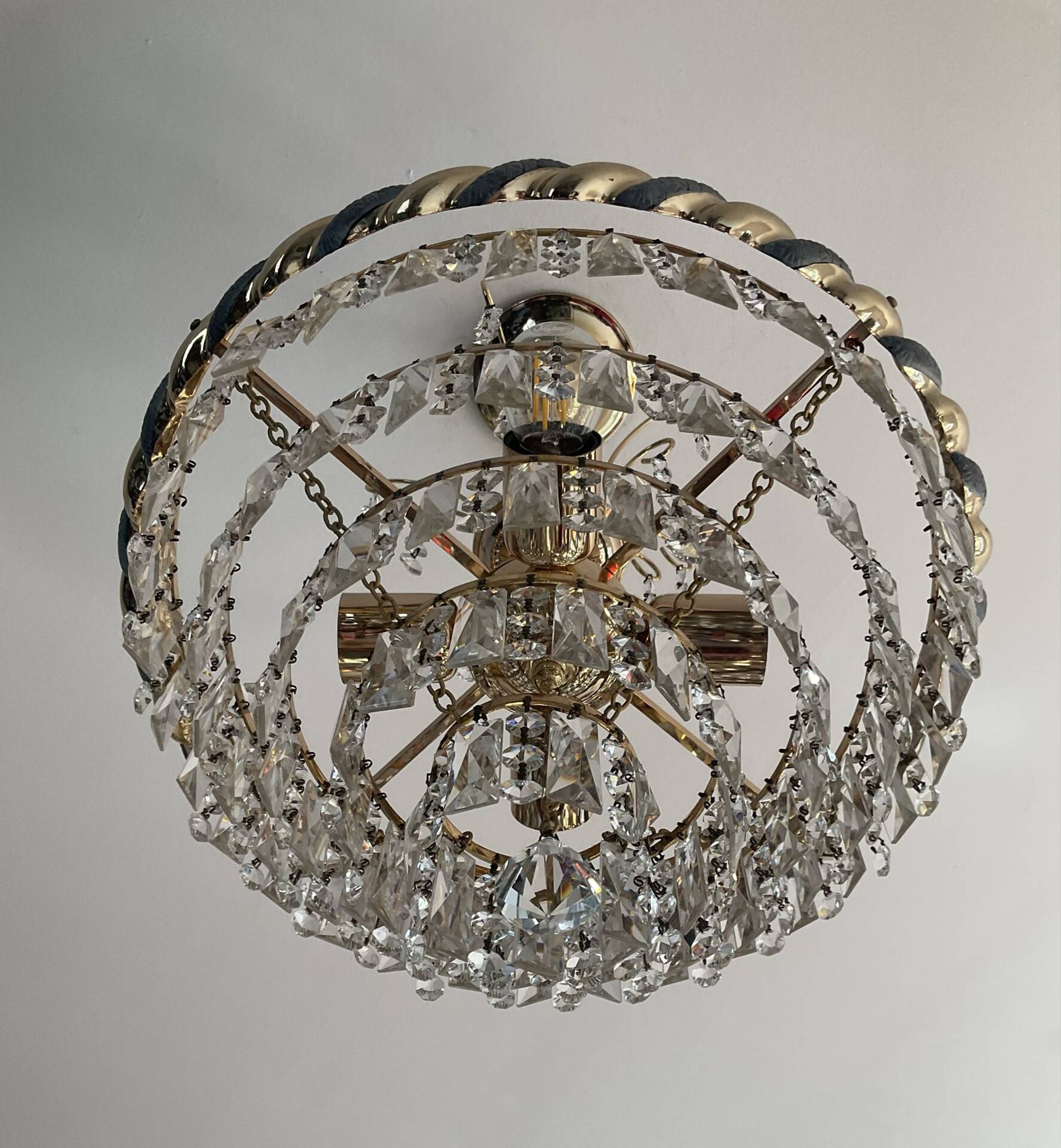 Crystal and brass chandelier with a cascade of pendants.