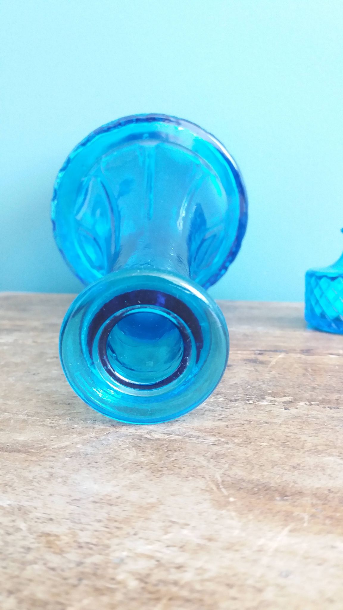 Turquoise glass carafe bottle with a stopper.