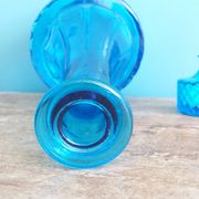 Turquoise glass carafe bottle with a stopper.