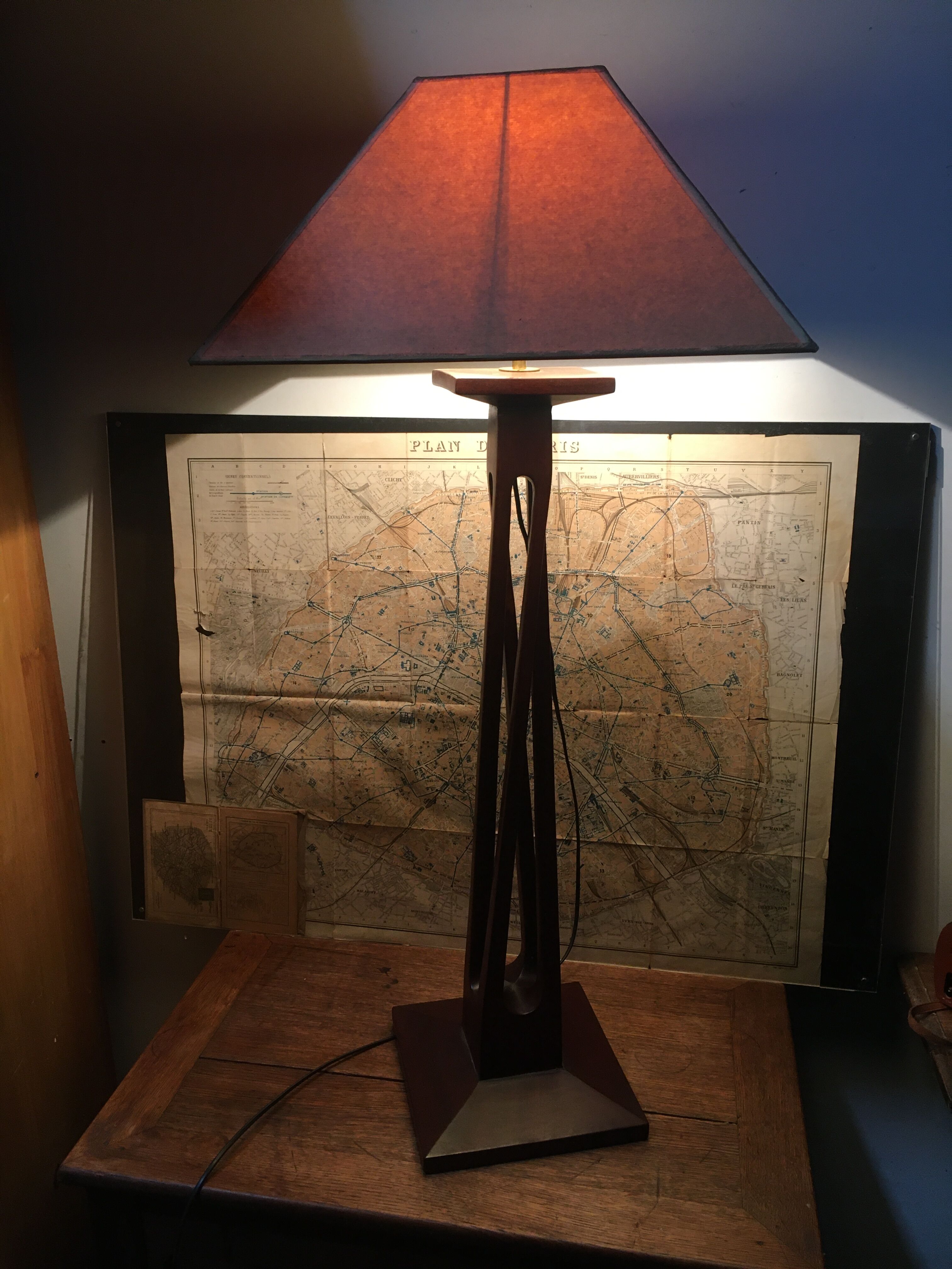 Mahogany lamp with a sculpted base.