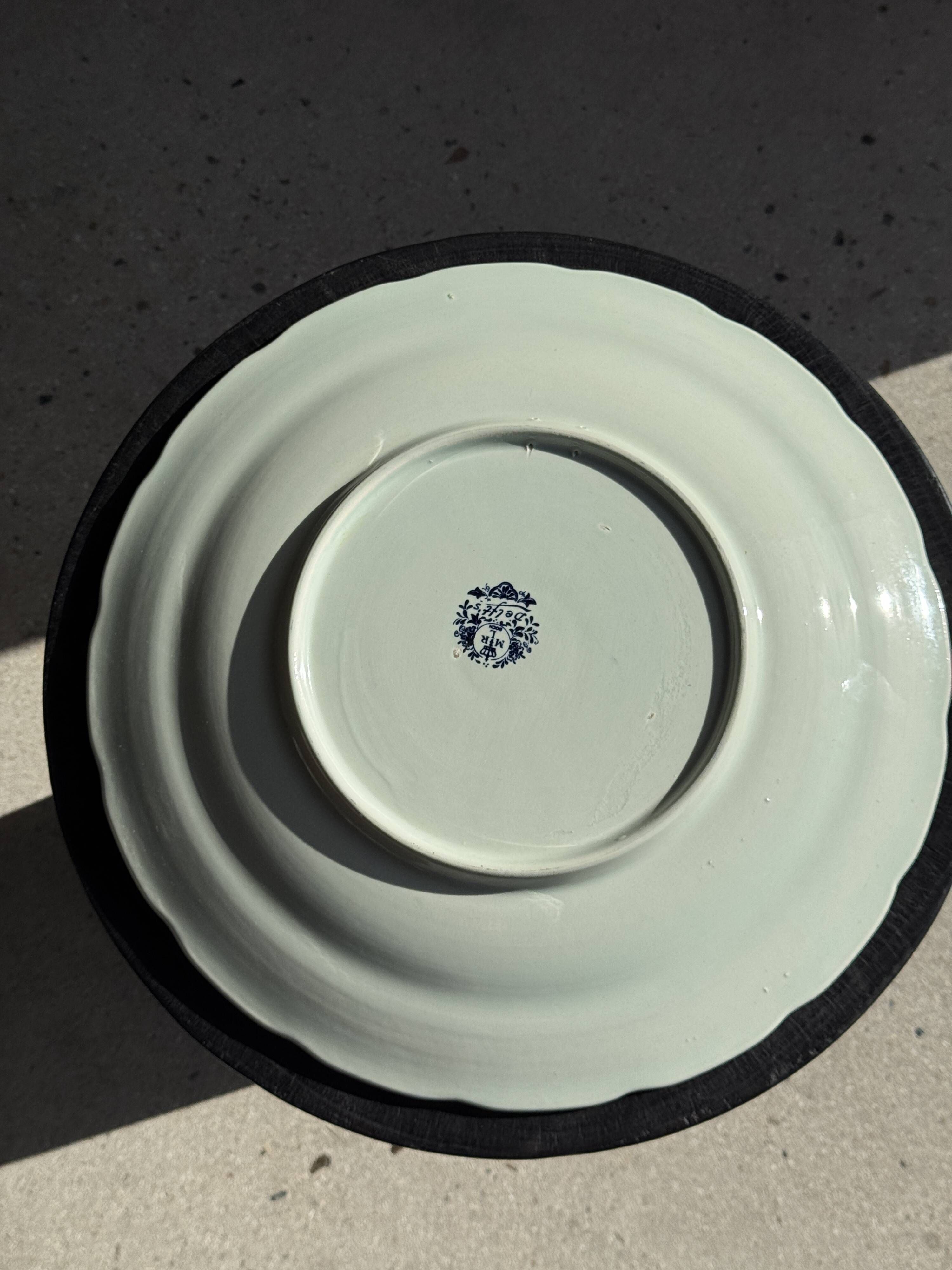 Vintage hollow circular plate in blue and white Boch pottery.