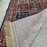 Vintage mechanical Turkish rug with box decoration on a red and navy blue background 139 x 68 cm