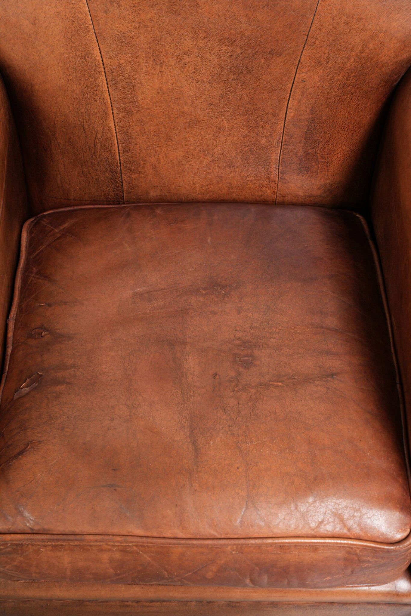 Comfortable vintage sheepskin armchair finished with decorative nails