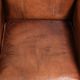 Comfortable vintage sheepskin armchair finished with decorative nails