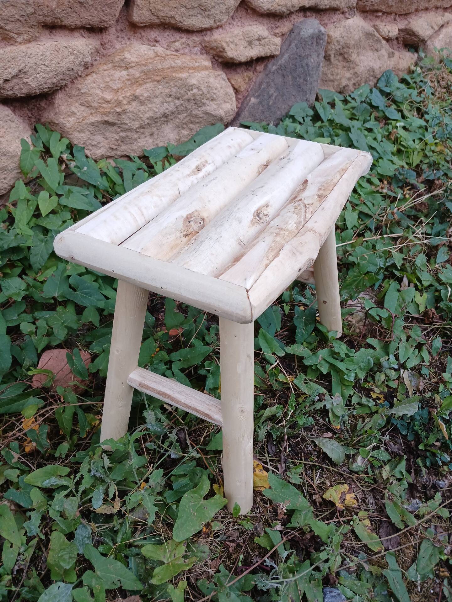 Small stool in raw wood